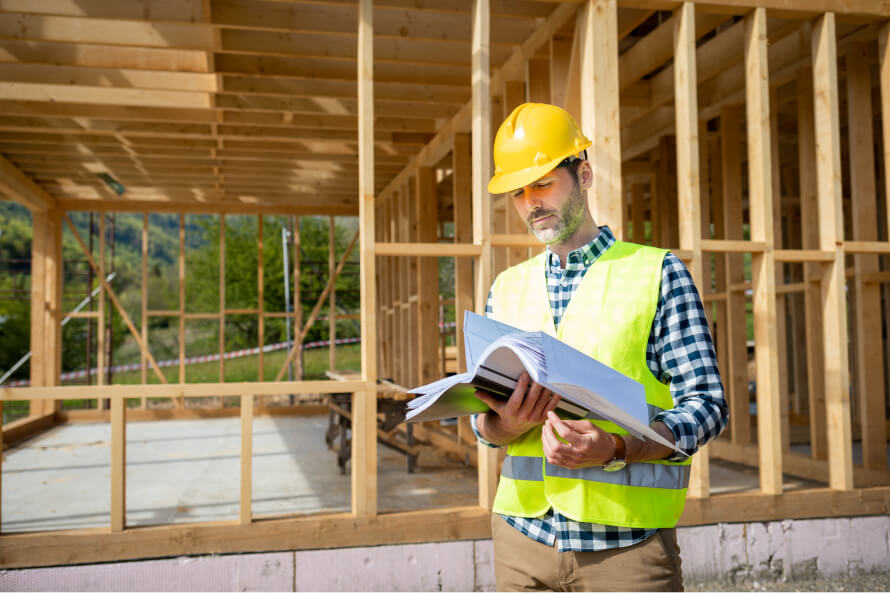 Restoration Contractor looking at blueprints for rebuilding a home