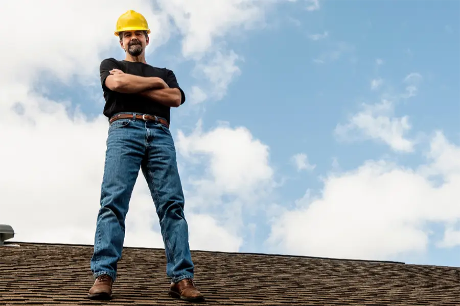 Contractor inspecting a roof for damage in Cumming Georgia